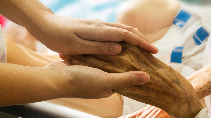 Young hands holding an elder's hand